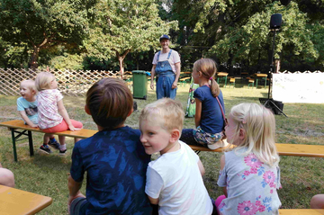 Eine Kindergruppe schaut Max Wully dem Bauchredner zu.